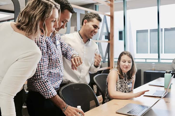 group of employees looking at screen